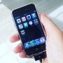 Playing with an original iPhone. It is sooo cute...
